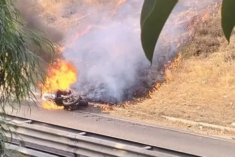 La moto in fiamme dopo l'incidente