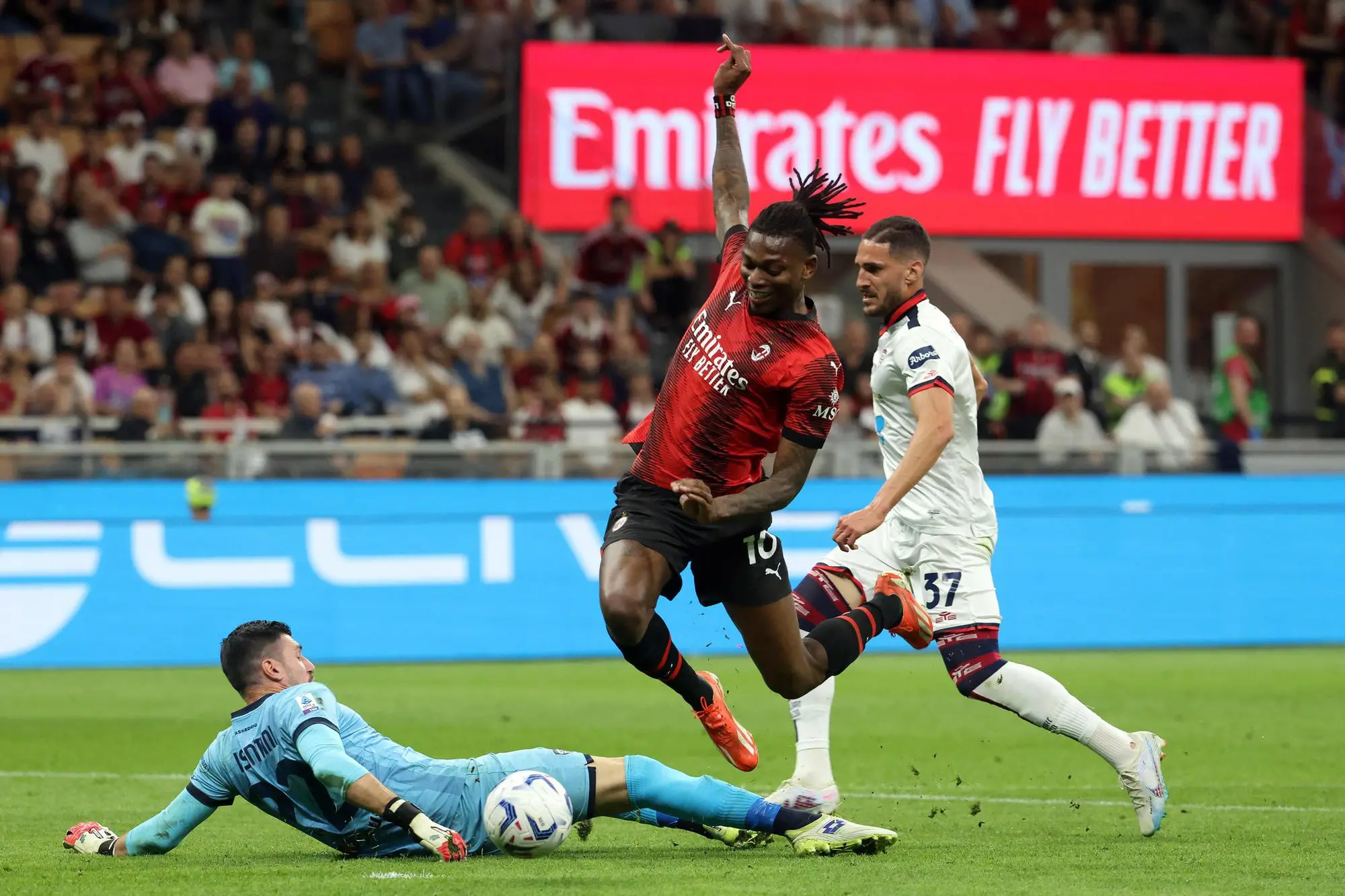 AC Milan’s Rafael Leao (C) challenges for the ball with Cagliari's goalkeeper Simone Scuffet (L) and his teammate Paulo Azzi during the Italian serie A soccer match between AC Milan and Cagliari at Giuseppe Meazza stadium in Milan, 11 May 2024. ANSA / MATTEO BAZZI