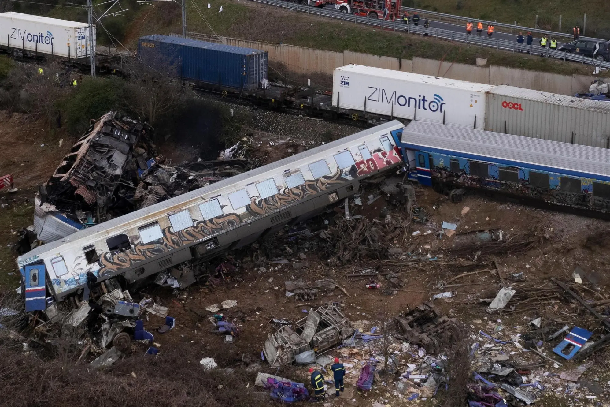 epaselect epa10496410 A picture taken with a drone shows firefighters and rescue crews working to extricate passengers from trains after a collision near Larissa city, Greece, 01 March 2023. At least 32 people were killed and more than 85 were injured when a passenger train collided with a freight train, in Tempi, central Greece, near the city of Larissa, the Greek Fire Service said. Out of the 85 injured persons, 53 still remain in hospital, according to the spokesperson of the Fire Service, Vassilis Vathrokogiannis. Rescue workers continue the search for survivors focusing on the first two carriages of the passenger train. EPA/ACHILLEAS CHIRAS