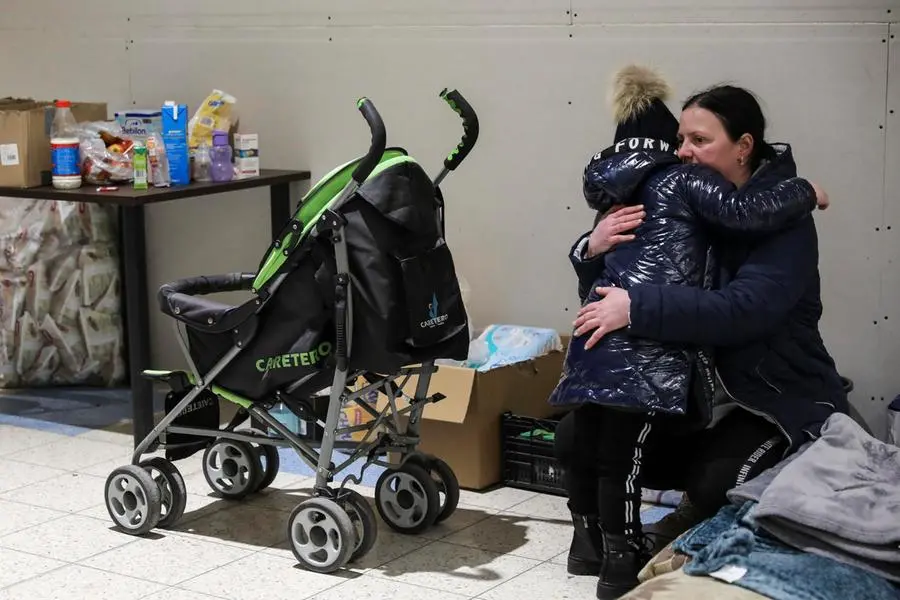 epa09798255 A woman hugs her child at the new refugee center that opened on 02 March in the CH-Tesco facility in the town of Przemysl, Poland, 02 March 2022 (issued 03 March). Hundreds of thousands of people have fled from Ukraine into neighboring countries since Russia began its military operation on 24 February. EPA/MIGUEL A. LOPES