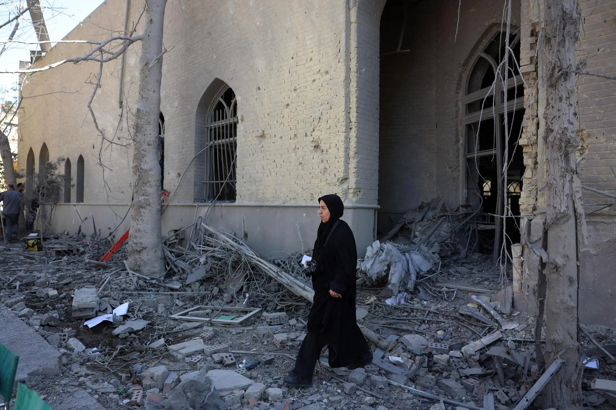 epa12872929 A member of the media works amid the debris of a damaged building at the Sharif University after an airstrike in Tehran, Iran, 07 April 2026. A joint Israeli and US military operation continues to target multiple locations across Iran since the early hours of 28 February 2026. EPA/ABEDIN TAHERKENAREH