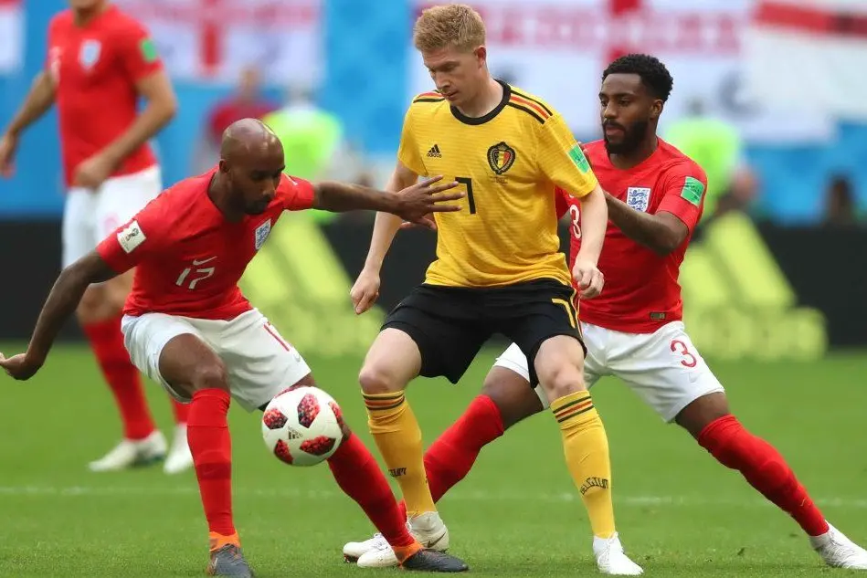 Al centro il belga De Bruyne pressato da Young e Rose
