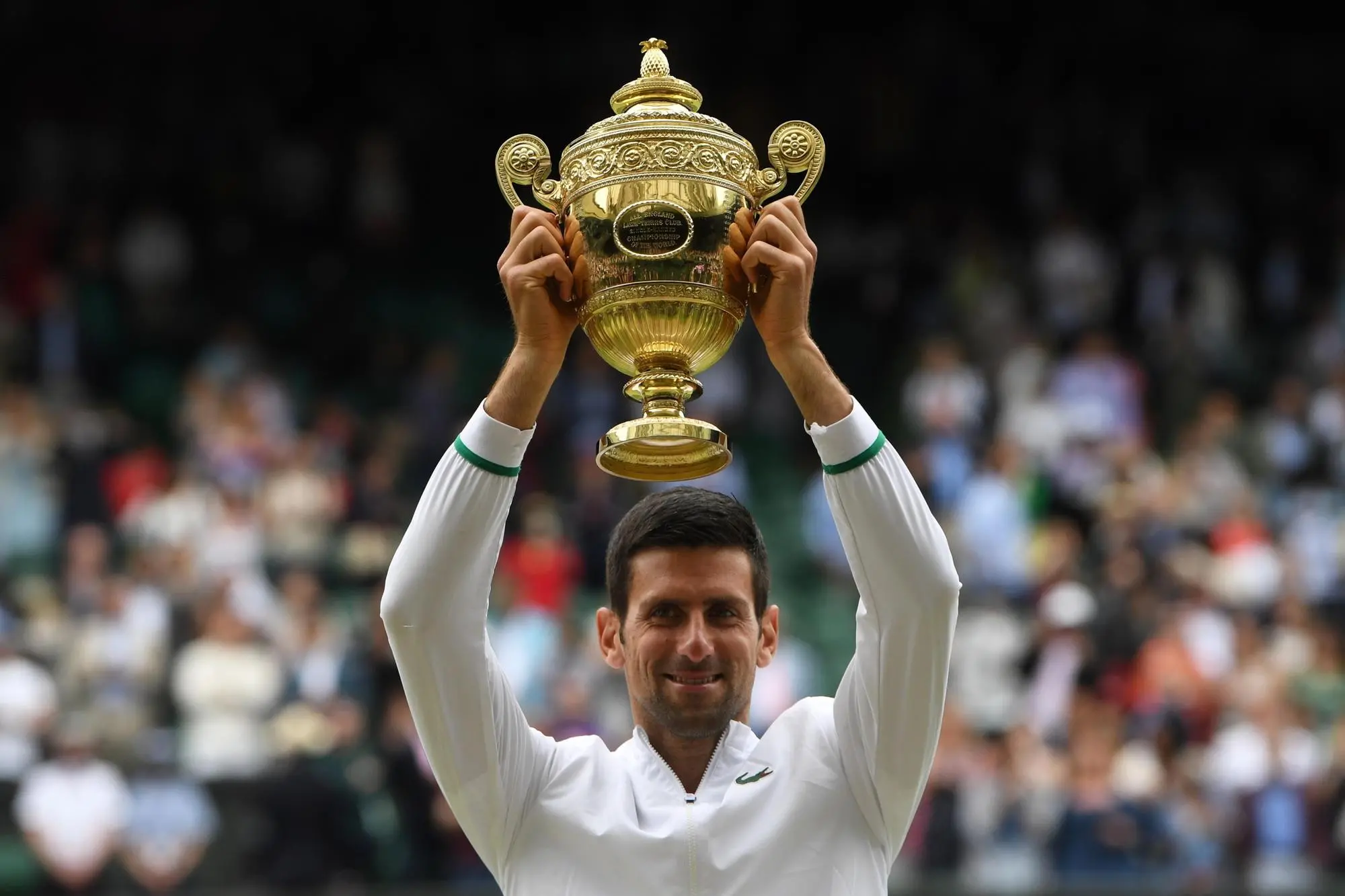 epa09337882 Novak Djokovic of Serbia poses for a photo with the trophy after winning the men's final against Matteo Berrettini of Italy at the Wimbledon Championships, Wimbledon, Britain 11 July 2021. EPA/NEIL HALL EDITORIAL USE ONLY