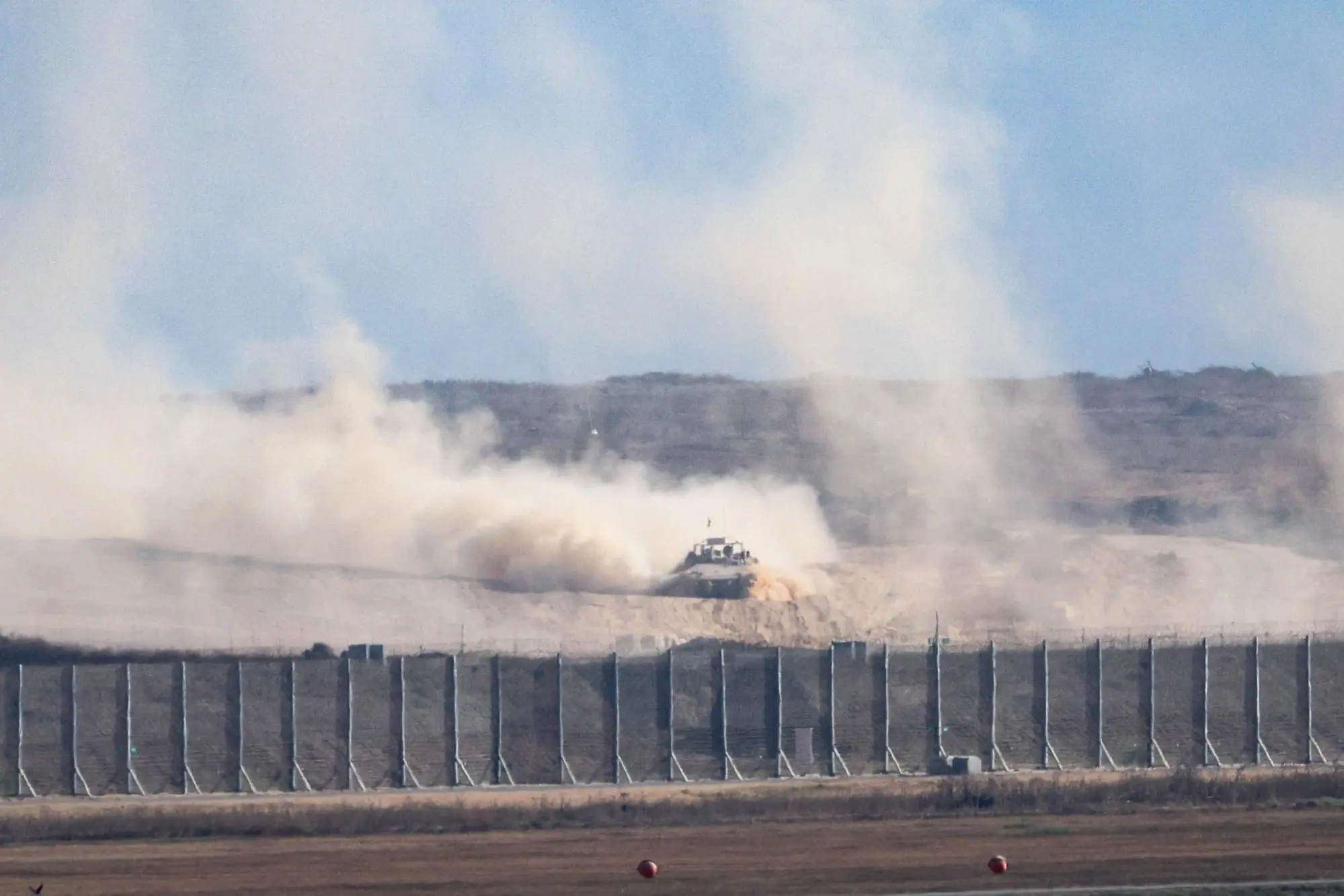 epa12235019 An Israeli defence forces APC vehicle drives along in the northern Gaza Strip near Beit Hanoun, as seen from the Israeli side of the border with Gaza Strip in southern Israel, 13 July 2025. EPA/ABIR SULTAN