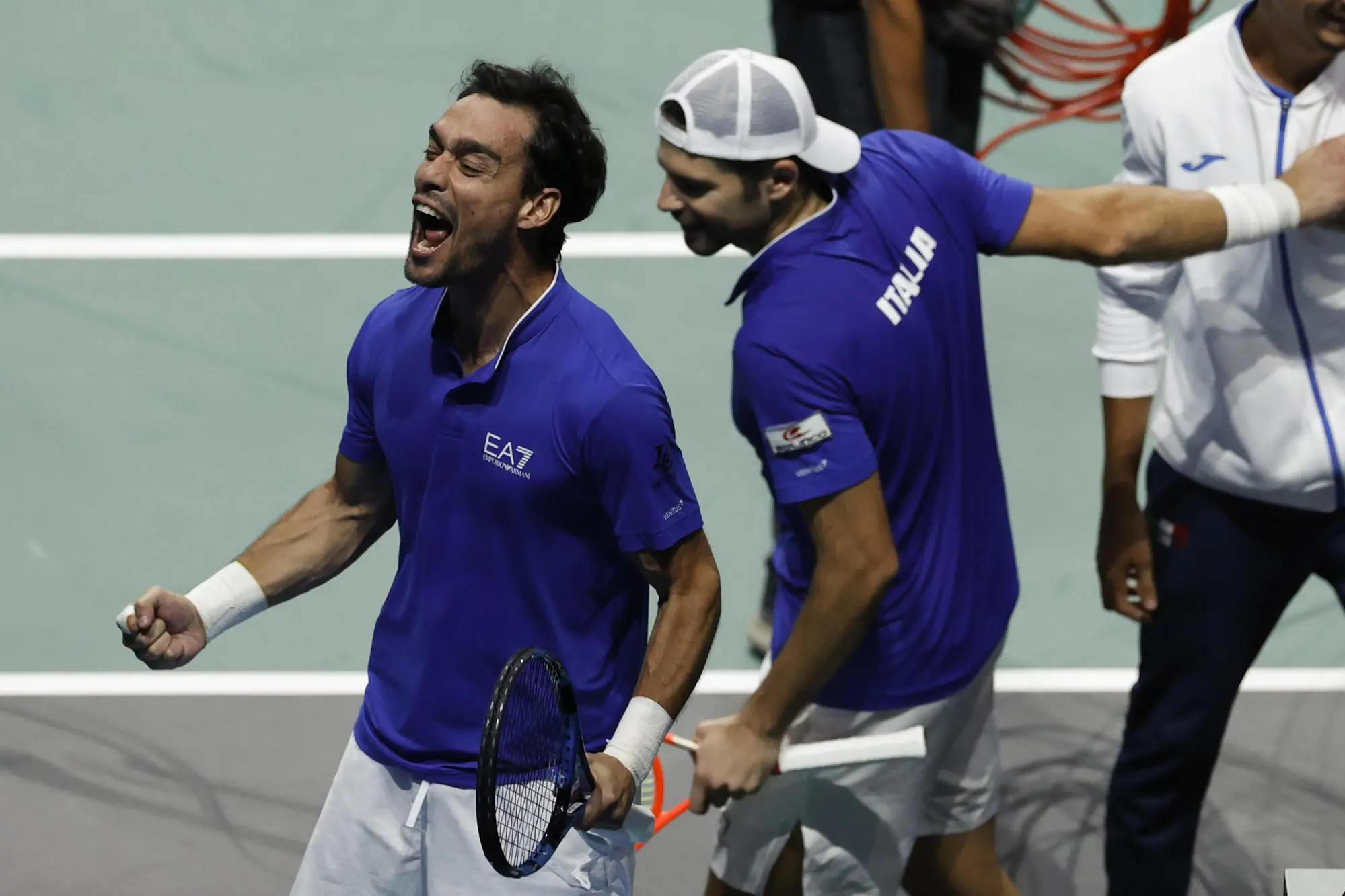 epa10325375 Italian tennis players Simone Bolelli (C) and Fabio Fognini (L) celebrate their victory over US Tommy Paul and Jack Sock following their Doubles match at the Davis Cup quarter-final between Italy and USA in Malaga, southern Spain, 24 November 2022. EPA/Julio Munoz