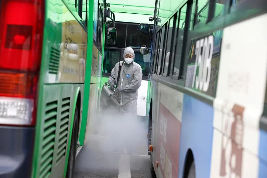 epa08248515 A worker sprays disinfectant, as a precaution against COVID-19, at a public bus parking lot in Seoul, South Korea, 26 February 2020. According to the Korea Center for Disease Control and Prevention (KCDC), 12 people in South Korea have died from the coronavirus, and 115 additional cases of COVID-19 have been reported on 26 February, bringing the nation's total infections to 1,261. The outbreak, which originated in the Chinese city of Wuhan, has so far killed at least 2,700 people with over 80,000 infected worldwide. EPA/JEON HEON-KYUN