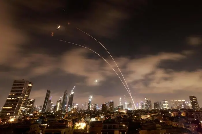 Israeli air defence systems are activated to intercept Iranian missiles over the Israeli city of Tel Aviv early on June 18, 2025. Israel and Iran exchanged fire again on June 17, the fifth day of strikes in their most intense confrontation in history, fuelling fears of a drawn-out conflict that could engulf the Middle East. (Photo by Menahem Kahana / AFP)