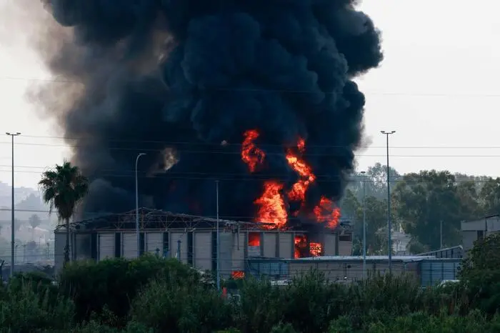 Smoke billows from a fire in a building in Herzliya near Tel Aviv following a fresh barrage of Iranian rockets on June 17, 2025. Israel's military said air raid sirens sounded in several areas of the country on June 17 after identifying missiles launched from Iran, as AFP journalists reported booms over Tel Aviv and Jerusalem. (Photo by Menahem KAHANA / AFP)