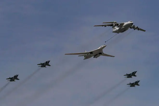 epa09931138 A Russian Tu-160 strategic bomber (C), an Il-78 aerial refuelling tanker (R) and MiG-31BM interceptor aircraft fly in formation during the Victory Day military parade general rehearsal in the Red Square in Moscow, Russia, 07 May 2022. The Victory Day military parade will take place 09 May 2022 in the Red Square to mark the victory of the Soviet Union over Nazi Germany in World War II. EPA/SERGEI ILNITSKY