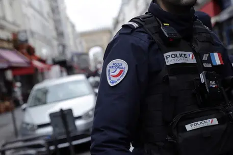 epa10377081 A French Police officer secures the perimeter on 'Rue d'Enghien' following a shooting incident near a Kurdish cultural centre in Paris, France, 23 December 2022. The Paris Police Prefecture annonced on its social media that a suspect was detained in connection to the incident. EPA/TERESA SUAREZ