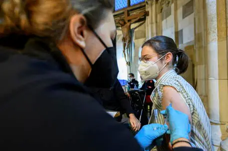 epa09592249 A woman receives a booster dose of Covid-19 vaccine inside the Saint Stephen's Cathedral in Vienna, Austria, 19 November 2021. Austrian Chancellor Alexander Schallenberg announced a mandatory vaccination against the SARS-CoV-2 coronavirus by February 2022, and a general nationwide lockdown to stem the ongoing pandemic of COVID-19 starting 22 November. EPA/CHRISTIAN BRUNA