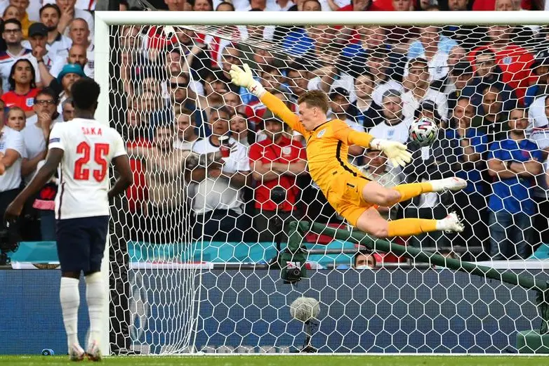 epa09329937 England goalkeeper Jordan Pickford (R) concedes Denmark's 1-0 lead during the UEFA EURO 2020 semi final between England and Denmark in London, Britain, 07 July 2021. EPA/Andy Rain / POOL (RESTRICTIONS: For editorial news reporting purposes only. Images must appear as still images and must not emulate match action video footage. Photographs published in online publications shall have an interval of at least 20 seconds between the posting.)