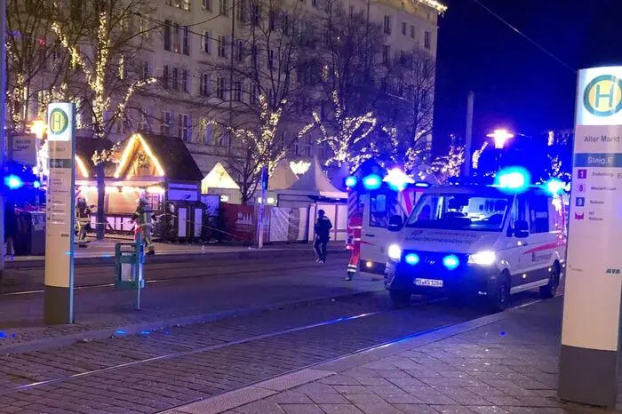 An ambulance stands next to a Christmas market, where a car crashed into a crowd killing and injuring people, according to media, on December 12, 2024 in Magdeburg. (Photo by Doerthe HEIN / dpa / AFP) / Germany OUT