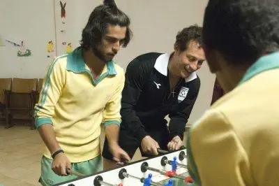 Stefano Accorsi gioca a biliardino con alcune comparse