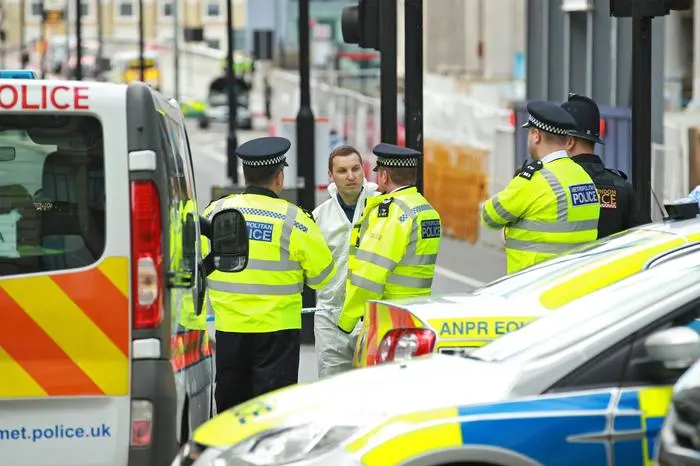 epaselect epa06009601 Forensic and police officers work on London Bridge a day after the previous night's terrorist incident, at Downing Street, in London, Britain, 04 June 2017. At least seven members of the public were killed and dozens injured after three attackers on late 03 June plowed a van into pedestrians and later randomly stabbed people on London Bridge and nearby Borough Market. The three attackers wearing fake suicide vests were shot dead by police who is treating the attack as a 'terrorist incident.' EPA/SEAN DEMPSEY