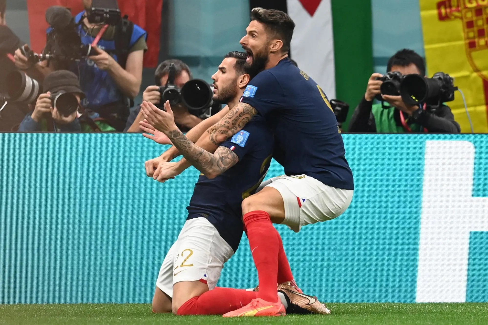 epa10366045 Theo Hernandez (L) of France celebrates with teammate Olivier Giroud after scoring the 1-0 during the FIFA World Cup 2022 semi final between France and Morocco at Al Bayt Stadium in Al Khor, Qatar, 14 December 2022. EPA/Georgi Licovski
