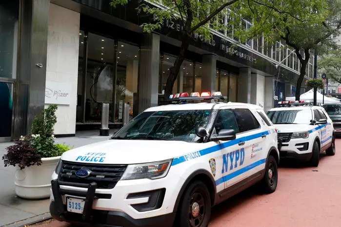 epa09473891 New York City Police Department (NYPD) cruisers are seen outside the headquarters of the pharmaceutical company Pfizer in New York, New York, USA, 17 September 2021. Vaccine advisers for the US Food and Drug Administration (FDA) are meeting on 17 September to discuss whether Americans need another booster shot of the Pfizer/BioNTech Covid-19 vaccine. EPA/JASON SZENES