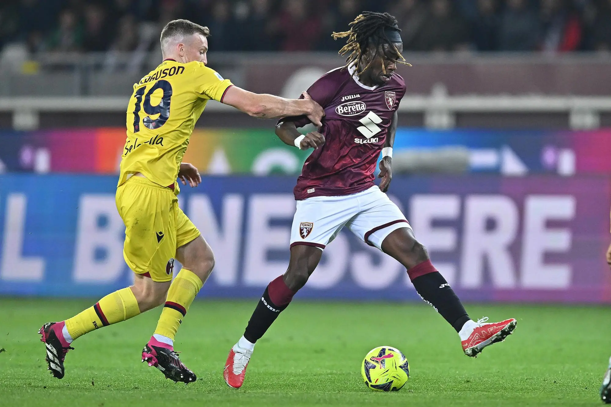 Torino's Yann Karamoh and Bologna's Lewis Ferguson in action during the Italian Serie A soccer match Torino FC vs Bologna FC at the Olimpico Grande Torino Stadium in Turin, Italy, 6 march 2023 ANSA/ALESSANDRO DI MARCO