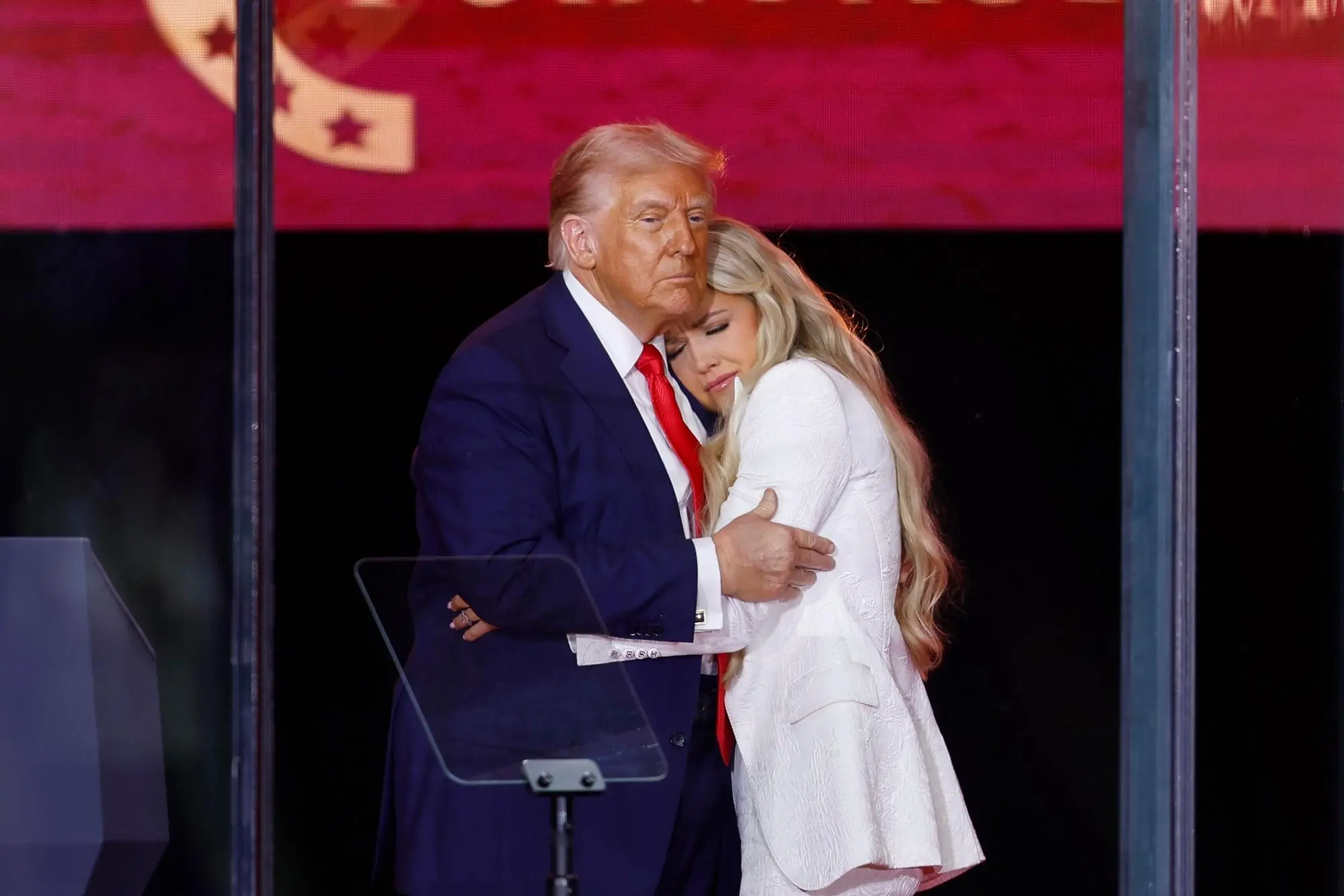 epaselect epa12396897 US President Donald Trump (L) and Erika Kirk (R), wife of Charlie Kirk, embrace on stage during the public memorial service of political activist Charlie Kirk at State Farm Stadium in Glendale, Arizona, USA, 21 September 2025. Kirk was shot and killed on 10 September during a stop on his American Comeback Tour organized by Turning Point USA at Utah Valley University. EPA/CAROLINE BREHMAN