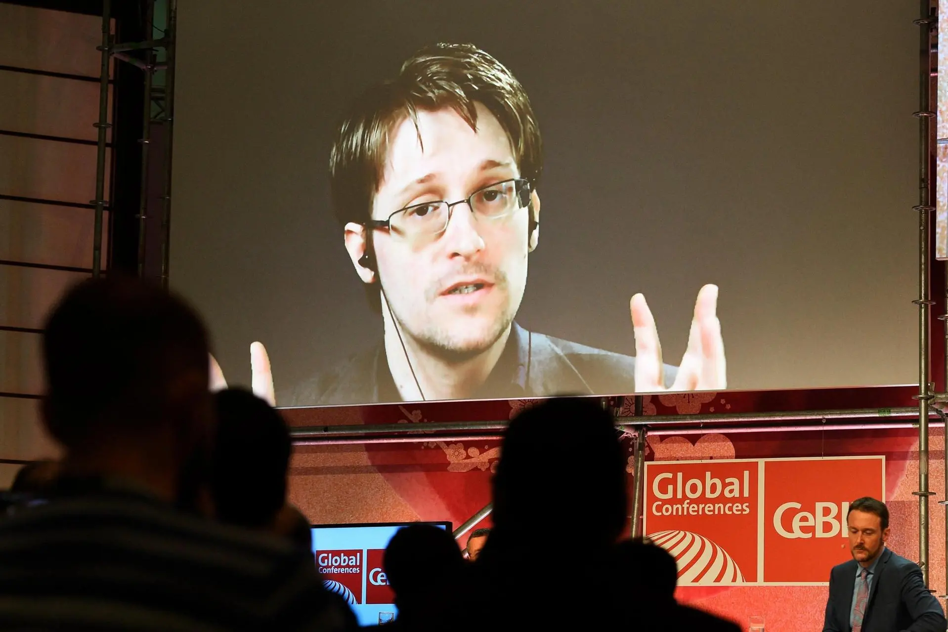 epa05862783 A handout photo made available by CeBIT showing US whistle-blower Edward Snowden on a large screen during the videoconference, 'Datasecurity and Privacy in the Age of Surveillance' at the CeBIT computing trade fair in Hanover, northern Germany, 21 March 2017. Snowden was connected from an unknown location from his exile in Russia. Reports state that more than 3.000 exhibitors from 70 countries are showing their products and solutions at the fair which expects to see about 200.000 visitors from 20 to 24 March 2017. EPA/RAINER JENSEN / CeBIT /HANDOUT HANDOUT EDITORIAL USE ONLY/NO SALES