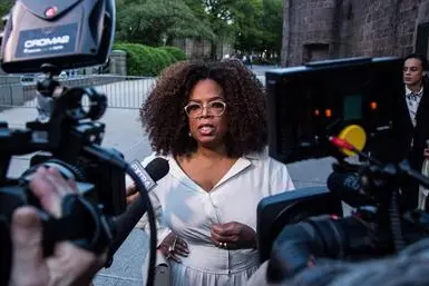 epa07574207 US media executive and talk show host Oprah Winfrey (C) arrives to the opening celebration of the Statue of Liberty Museum on Liberty Island at the Statue Cruises Terminal in Battery Park in New York, New York, USA, 15 May 2019. EPA/ALBA VIGARAY