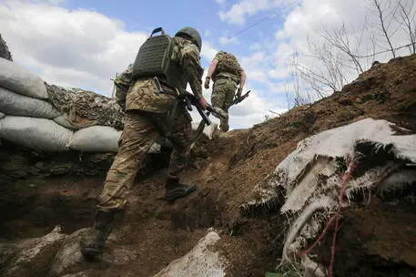 epaselect epa09914990 Ukrainian servicemen walk to patrol a territory in Luhanske village of Donetsk area, Ukraine, 28 April 2022 amid the Russian invasion. Russian troops entered Ukraine on 24 February resulting in fighting and destruction in the country and triggering a series of severe economic sanctions on Russia by Western countries. EPA/STR