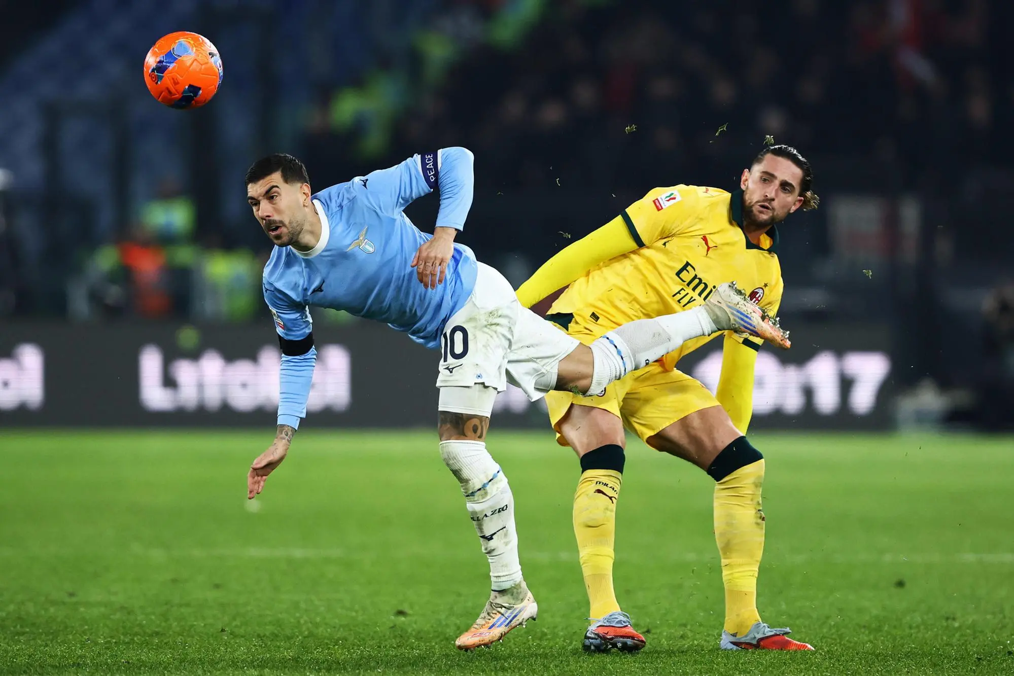 Mattia Zaccagni of Lazio vies for the ball with Adrien Rabiot of Milan during the Italian Cup round of 16 soccer match between SS Lazio and AC Milan at Olimpico Stadium in Rome, Italy, 04 December 2025. ANSA/FEDERICO PROIETTI