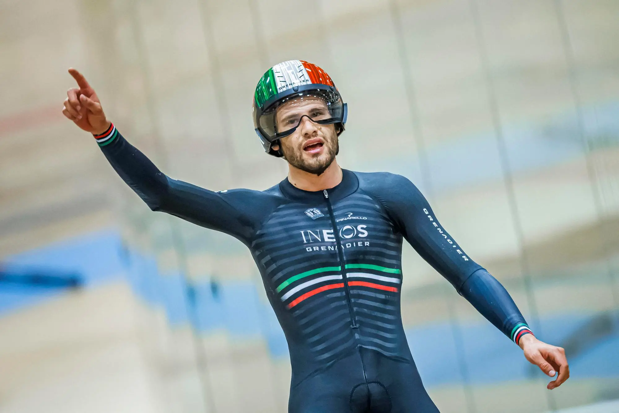 Ineos Grenadiers' Italian rider Filippo Ganna celebrates after breaking the hour record with a distance of 56.792km in the Velodrome Suisse, an indoor velodrome in Grenchen, northern Switzerland on October 8, 2022. (Photo by Valentin FLAURAUD / AFP)