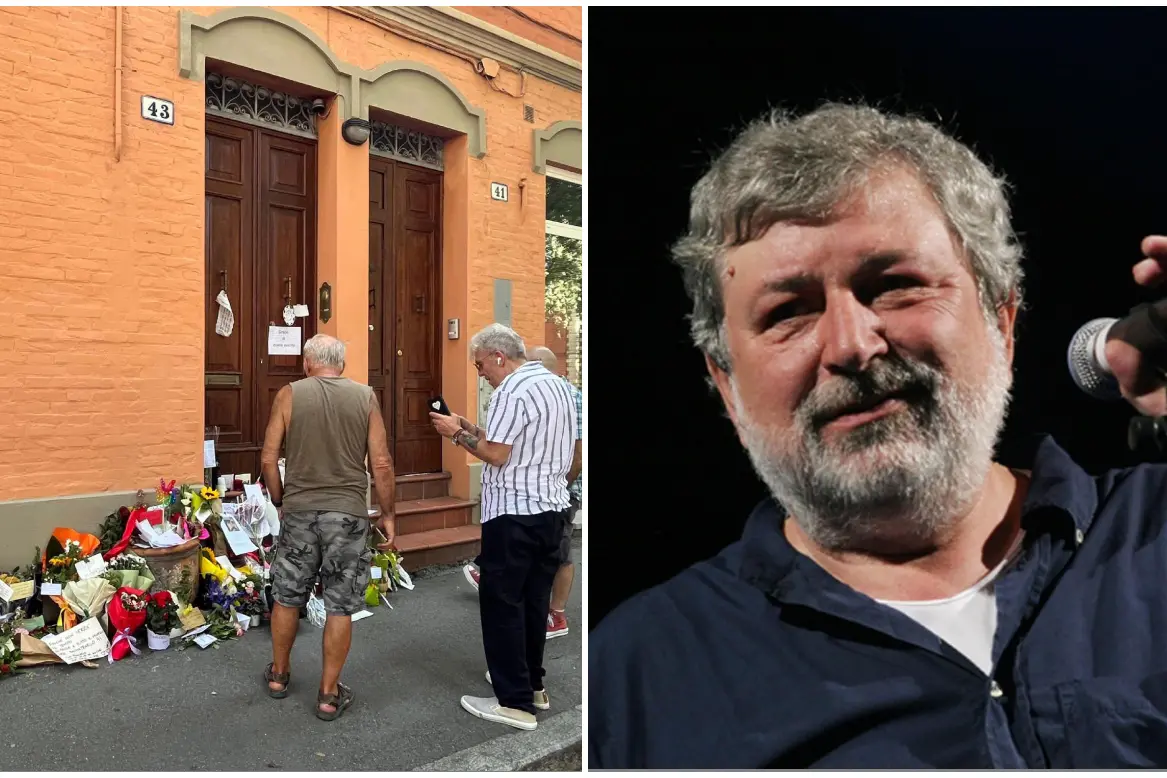 Fiori davanti alla casa di via Paolo Fabbri 43 per Guccini, a destra (Ansa)