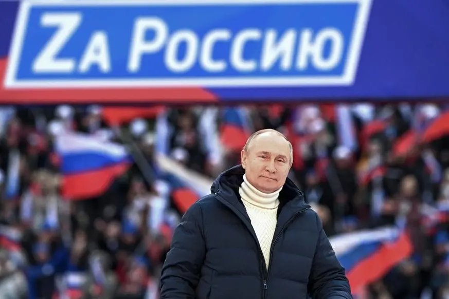 epa09834243 Russian President Vladimir Putin delivers a speech during a concert marking the 8th anniversary of Crimea's reunification with Russia at the Luzhniki stadium in Moscow, Russia, 18 March 2022. The banner holds letter Z and says 'For Russia'. The letter Z, painted on Russian military vehicles in Ukraine, has quickly become a symbol of support a 'special military operation' carried out by the Russian Armed Forces in Ukraine. Russia in 2014 annexed the Black Sea peninsula, shortly after Crimeans voted in a disputed referendum to secede from Ukraine. EPA/RAMIL SITDIKOV / SPUTNIK POOL