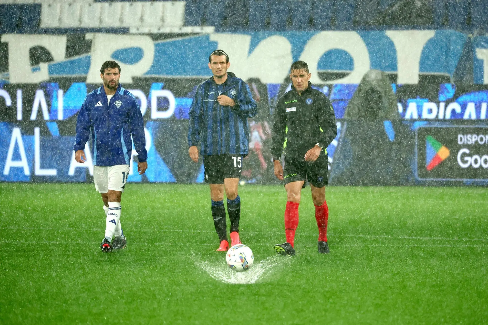 Referee Paride Tremolada checks the conditions of the field with capitains Atalanta's Marten De Roon and Como’s Patrick Cutrone during the Italian Serie A soccer match Atalanta BC vs Como at Gewiss Stadium in Bergamo, Italy, 23 September 2024. ANSA/MICHELE MARAVIGLIA