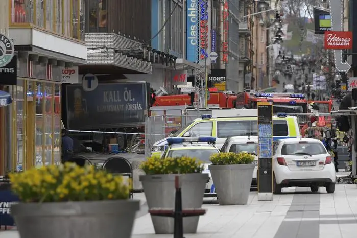 epa05894623 Swedish police and emergency services gather at the site where a truck reportedly crashed into a department store in central Stockholm, Sweden, 07 April 2017. A truck has driven into a department store on Drottninggatan street (Queen Street) in central Stockholm, media reported quoting local police. According to initial reports, at least three people were killed and others were injured in the incident, media added. EPA/ANDERS WIKLUND SWEDEN OUT