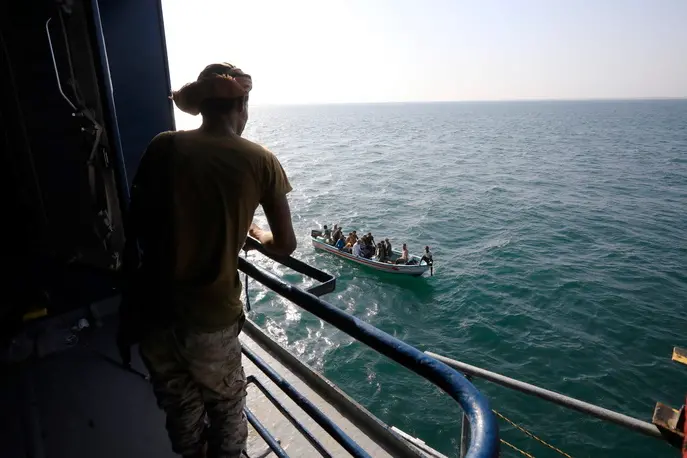 epa11014311 A boat carries people as a Houthi fighter keeps watch on the deck of the Galaxy Leader cargo ship, seized by the Houthis offshore of the Al-Salif port on the Red Sea in the province of Hodeidah, Yemen, 05 December 2023 (issued 06 December 2023). Yemen's Houthis on 06 December 2023 claimed responsibility for the launch of the barrage of ballistic missiles toward Israel in support of the Palestinian people in the Gaza Strip, according to a statement by Houthis spokesman Yahya Saree. The Houthis vowed to continue their efforts to prevent Israeli ships from navigating in the Arabian and Red Seas, in retaliation for Israel's airstrikes on the Gaza Strip. Thousands of Israelis and Palestinians have died since the militant group Hamas launched an unprecedented attack on Israel from the Gaza Strip on 07 October, and the Israeli strikes on the Palestinian enclave which followed it. EPA/YAHYA ARHAB
