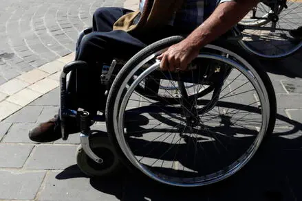 epa09617108 A disabled Yemeni rides a wheelchair on the eve of the International Day of Persons with Disabilities, at a street in Sana’a, Yemen, 02 December 2021. Approximately three million people with disabilities live in war-ridden Yemen, UNICEF has estimated. The International Day of People with Disability, inaugurated by the United Nations in 1992, is annually observed on 03 December around the world to mobilize support for rights and well-being of persons with disabilities in all spheres of society and development. EPA/YAHYA ARHAB