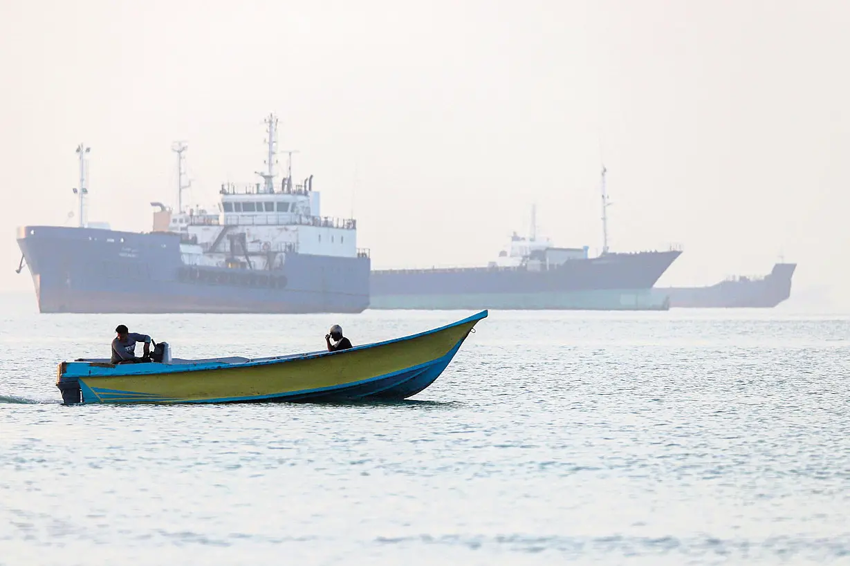 epa13009258 A handout photo made available by Isna News Agency shows Iranian fishermen steering a boat past ships stuck in the Strait of Hormuz, along the coast of Bandar Abbas, in southern Iran, 01 June 2026. According to Iranian state media, the military's central command warned all vessels to secure Islamic Revolution Guards Corps (IRGC) Navy clearance to pass through the strait or face maritime security risks. EPA/AMIRHOSSEIN KHORGOOEI/ ISNA NEWS AGENCY HANDOUT RESTRICTIONS: NO Access Israel Media/Persian Language TV Stations Outside Iran/Strictly No Access BBC Persian/VOA Persian/Manoto TV/Iran International TV. (As mandated by Iran's Directorate General for Foreign Media) -- HANDOUT EDITORIAL USE ONLY/NO SALES