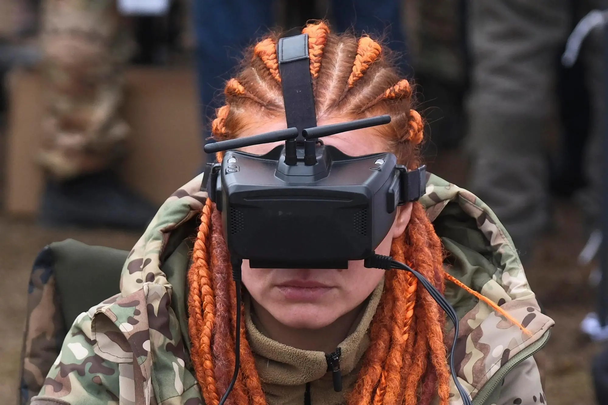 epaselect epa11861177 A Ukrainian soldier wears drone goggles as she tests a fiber-optic-controlled drone designed for the Ukrainian Armed Forces, near Kyiv, Ukraine, 29 January 2025. Drones controlled by fiber optics can infiltrate enemy lines undetected by electronic warfare devices, and engage targets from outside the enemy's line of sight. EPA/VITALII NOSACH