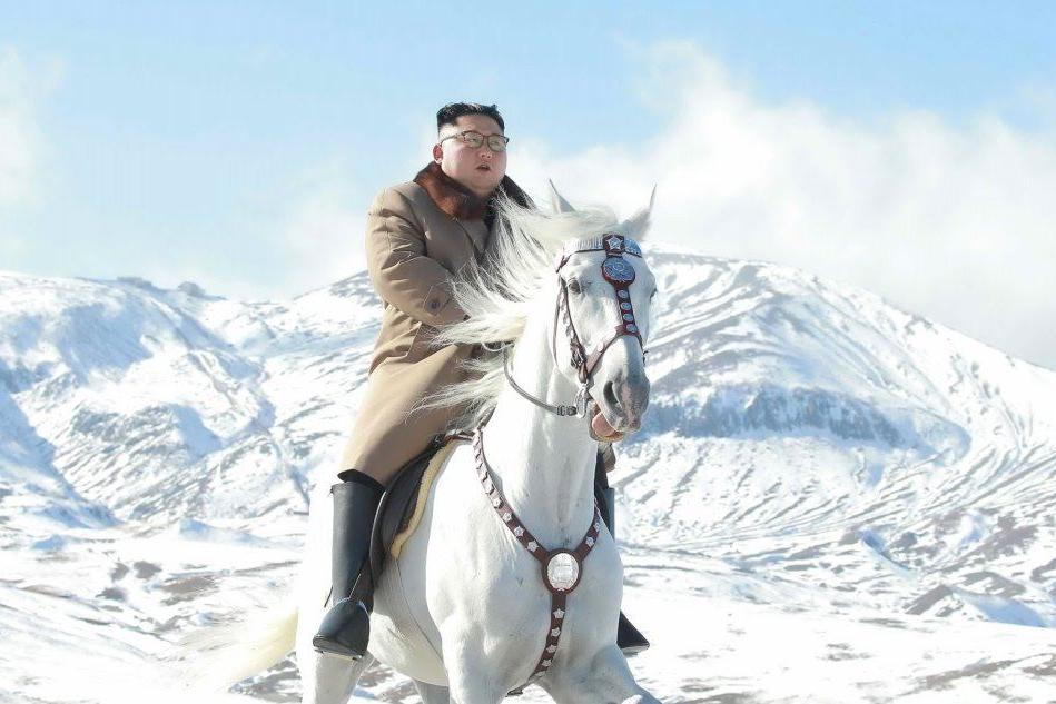 Kim in sella a un cavallo bianco tra le cime innevate