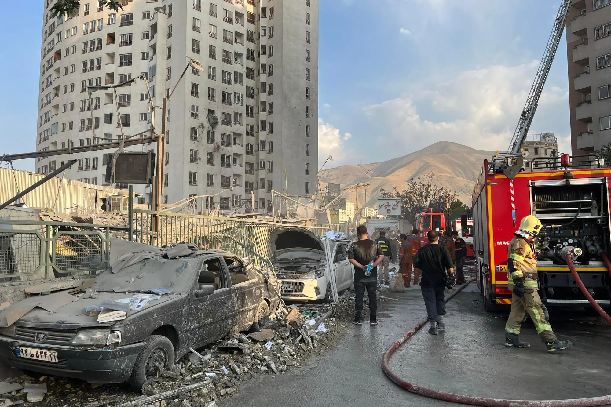 epaselect epa12172720 Fire fighters work outside a building that was hit by Israeli air strikes north of Tehran, Iran, 13 June 2025. Israel confirms it has launched strikes on Iran's 'nuclear program' as blasts are heard across the country. The strikes are part of Operation Rising Lion, Israel's Prime Minister Benjamin Netanyahu said, adding Iran was a threat to "Israel's very survival". EPA/ABEDIN TAHERKENAREH