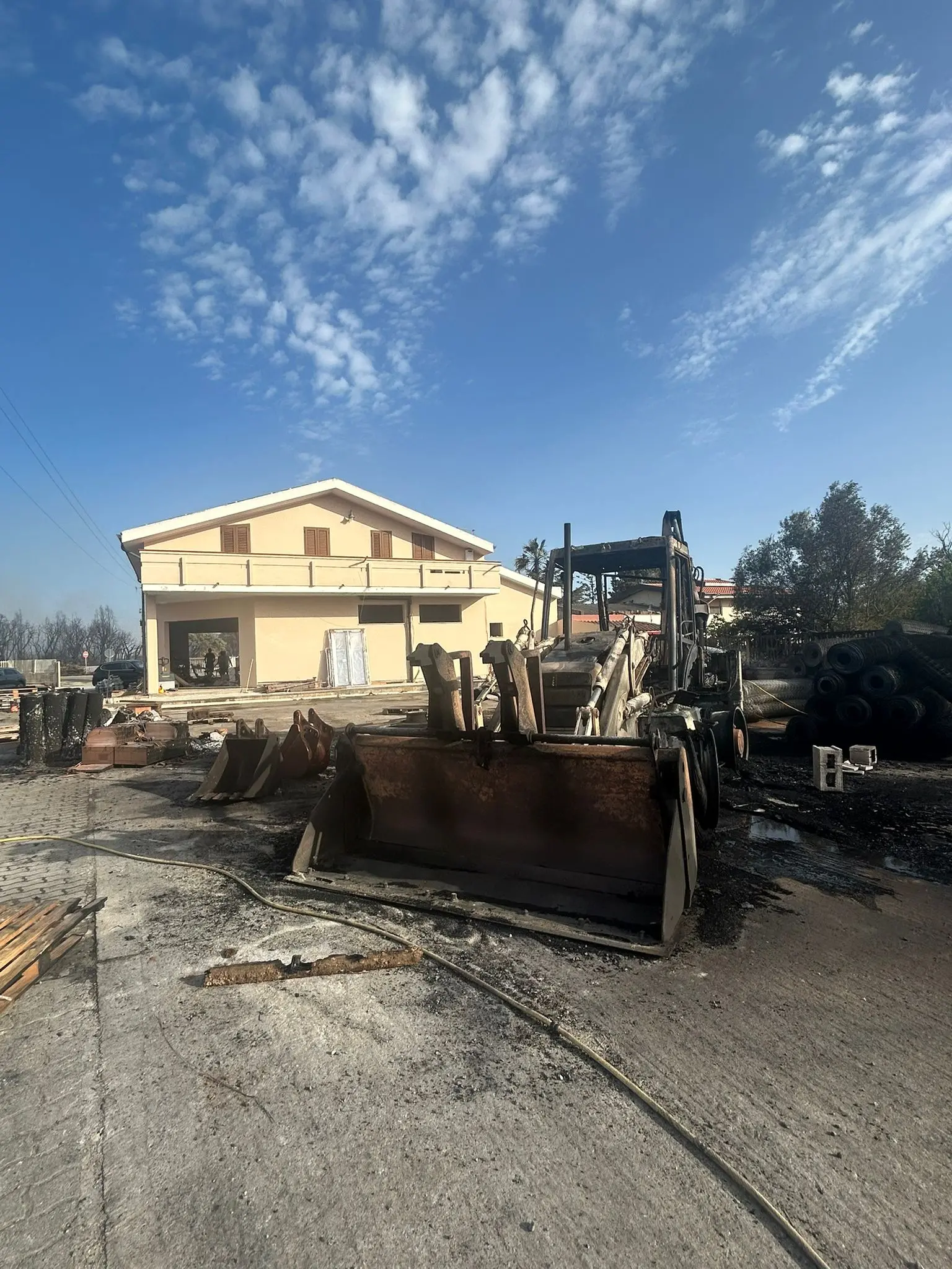 Una ruspa distrutta dalle fiamme per l'incendio a Carbonia (foto Murru)