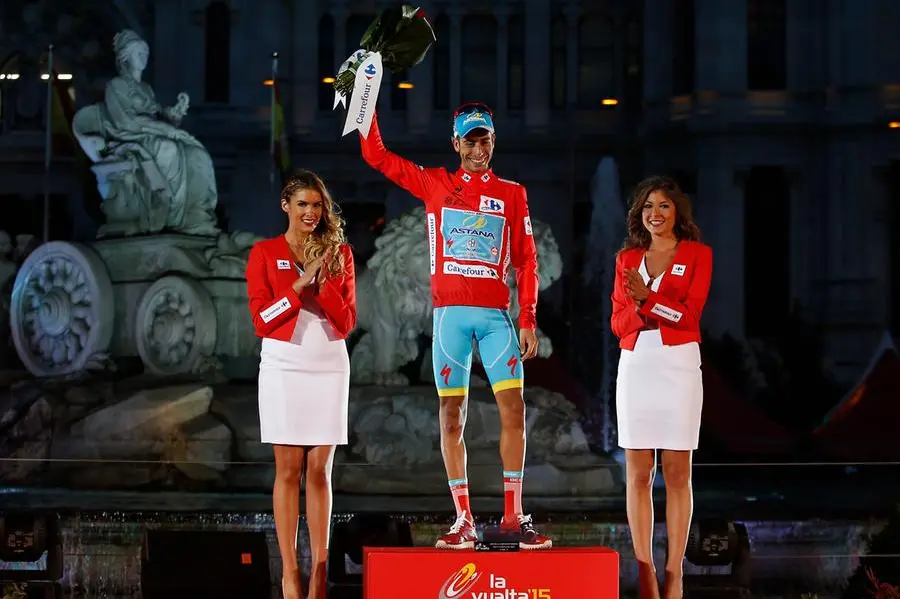Astana's rider Fabio Aru from Italy, centre, poses with the trophy in front of the Cibeles statue after winning the Spanish La Vuelta cycling tour that finished in Madrid, Spain, Sunday Sept. 13, 2015. (AP Photo/Francisco Seco)