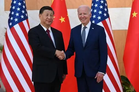 US President Joe Biden (R) and China's President Xi Jinping (L) shakes hands as they meet on the sidelines of the G20 Summit in Nusa Dua on the Indonesian resort island of Bali on November 14, 2022. (Photo by SAUL LOEB / AFP)