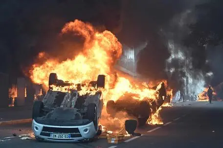 Un veicolo in fiamme a Parigi (foto Ansa)