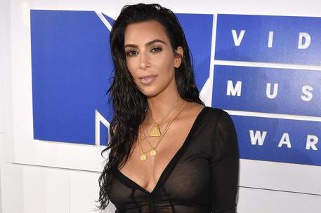 FILE - In this Aug. 28, 2016 file photo, Kim Kardashian West arrives at the MTV Video Music Awards in New York. Kardashian West is suing online media outlet, MediaTakeOut.com, saying she was wrongly portrayed as a liar and thief after she was attacked in Paris. Police say armed robbers forced their way into a private residence where Kardashian West was staying on Oct. 3, tied her up and stole $10 million worth of jewelry. (Photo by Chris Pizzello/Invision/ANSA/AP, File)