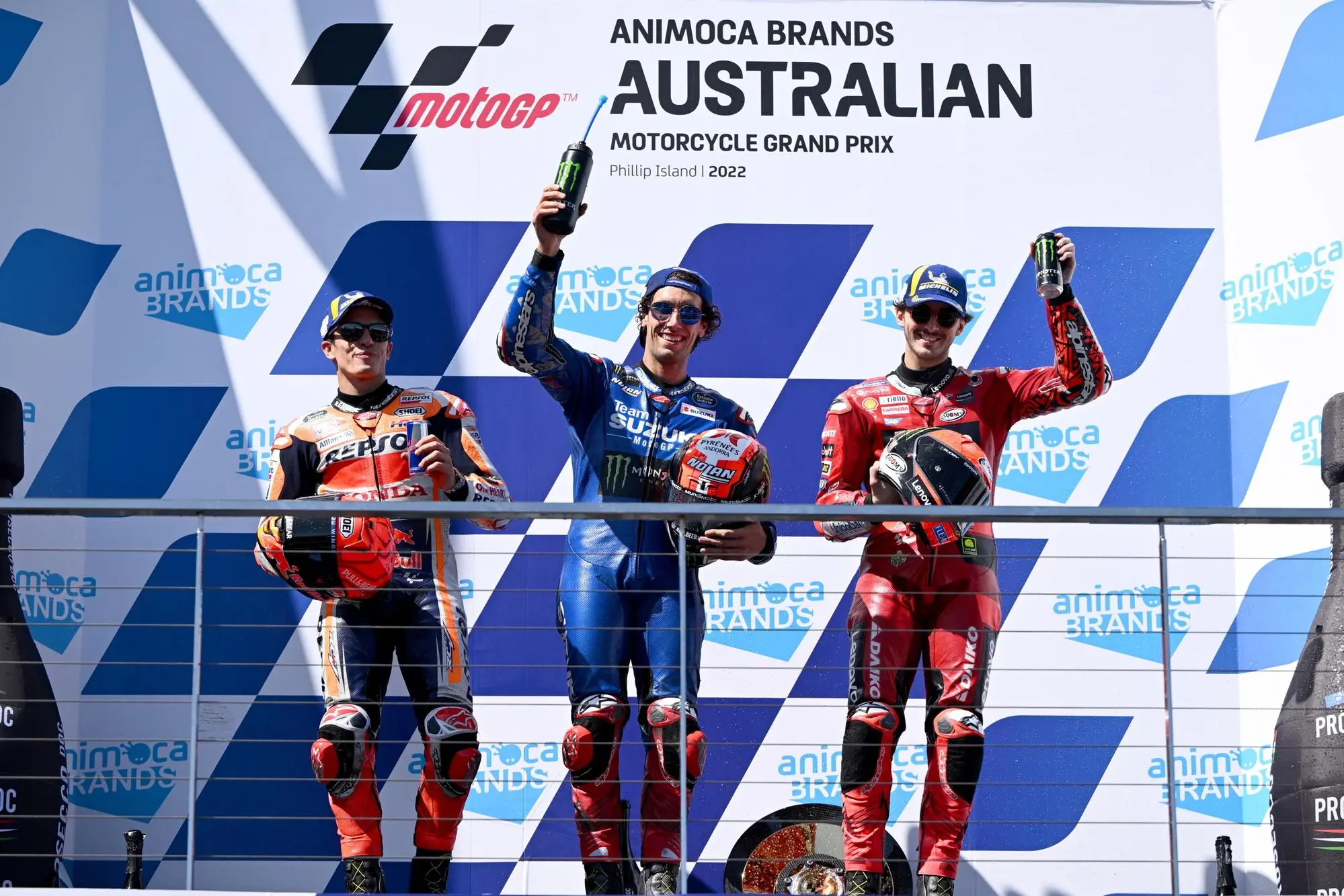 epa10246444 First place Alex Rins of Spain riding for Suzuki Ecstar (C) celebrates on the podium with second place Marc Marquez of Spain riding for Repsol Honda Team (L) and third place Francesco Bagnaia of Italy riding for Ducati Lenovo Team (R) after the MotoGP race race at the Australian Motorcycle Grand Prix at the Phillip Island Grand Prix Circuit on Phillip Island, Victoria, Australia, 16 October 2022. EPA/JOEL CARRETT AUSTRALIA AND NEW ZEALAND OUT