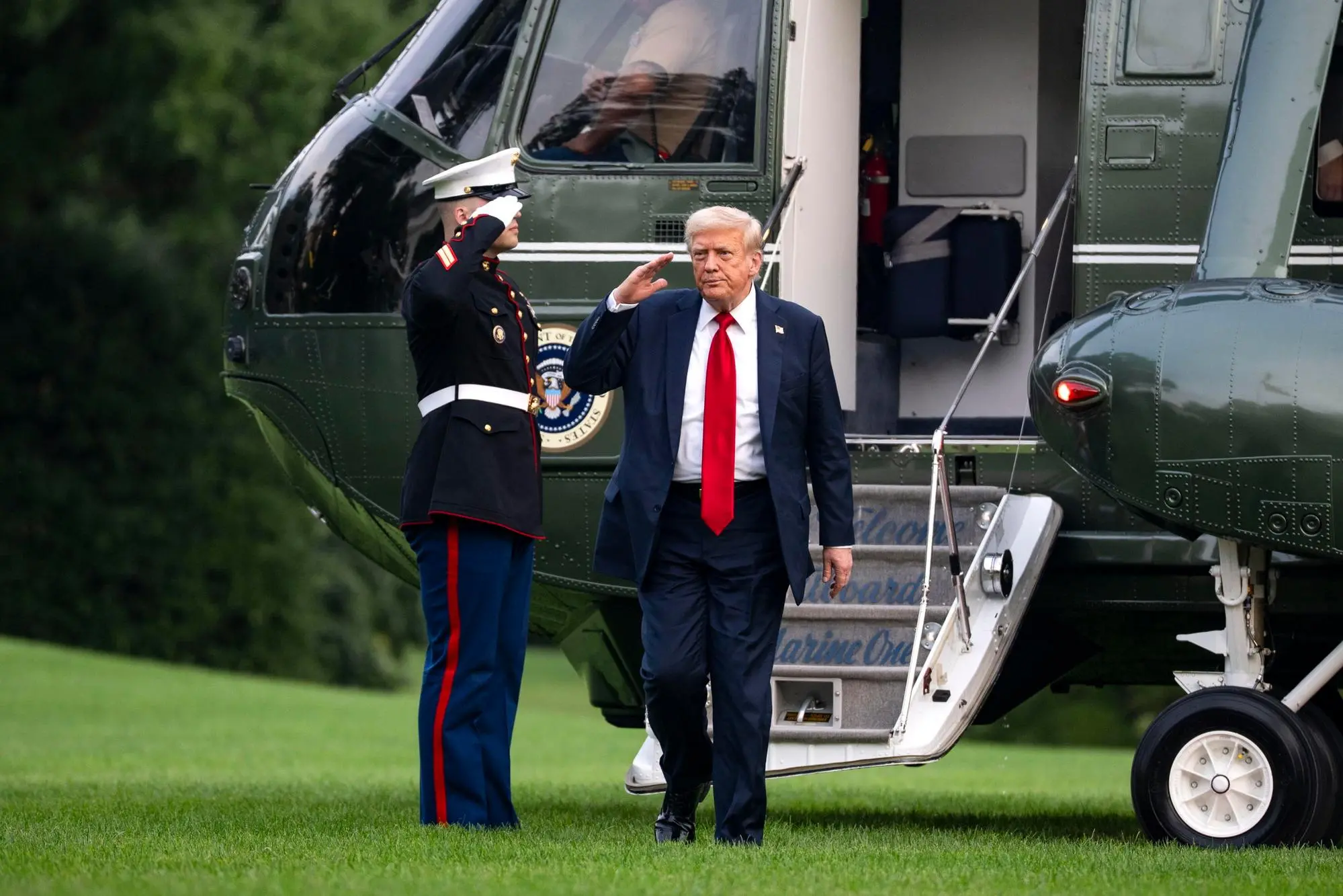 epa12236687 US President Donald Trump salutes after exiting Marine One on the South Lawn of the White House in Washington, DC, USA, 13 July 2025. Trump is returning after attending the FIFA Club World Cup 2025 Final match between Chelsea FC and Paris Saint-Germain, in East Rutherford, New Jersey. EPA/BONNIE CASH / POOL