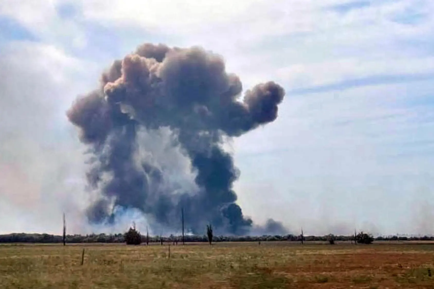 epa10112853 A handout picture made available by the Department of Information and Press Service of the Head of the Republic of Crimea shows smoke rising after detonations of air munisions at the Saki airfield near the Novofedorovka settlement, Crimea, 09 August 2022. Violation of the fire safety rules is being probed as the main cause of the explosion of ammunition at the Saki airfield in Crimea; there is no sign that they were blown up intentionally, a source at the Russian Defense Ministry said. EPA/Press Office of Head of Crimea HANDOUT MANDATORY CREDIT HANDOUT EDITORIAL USE ONLY/NO SALES