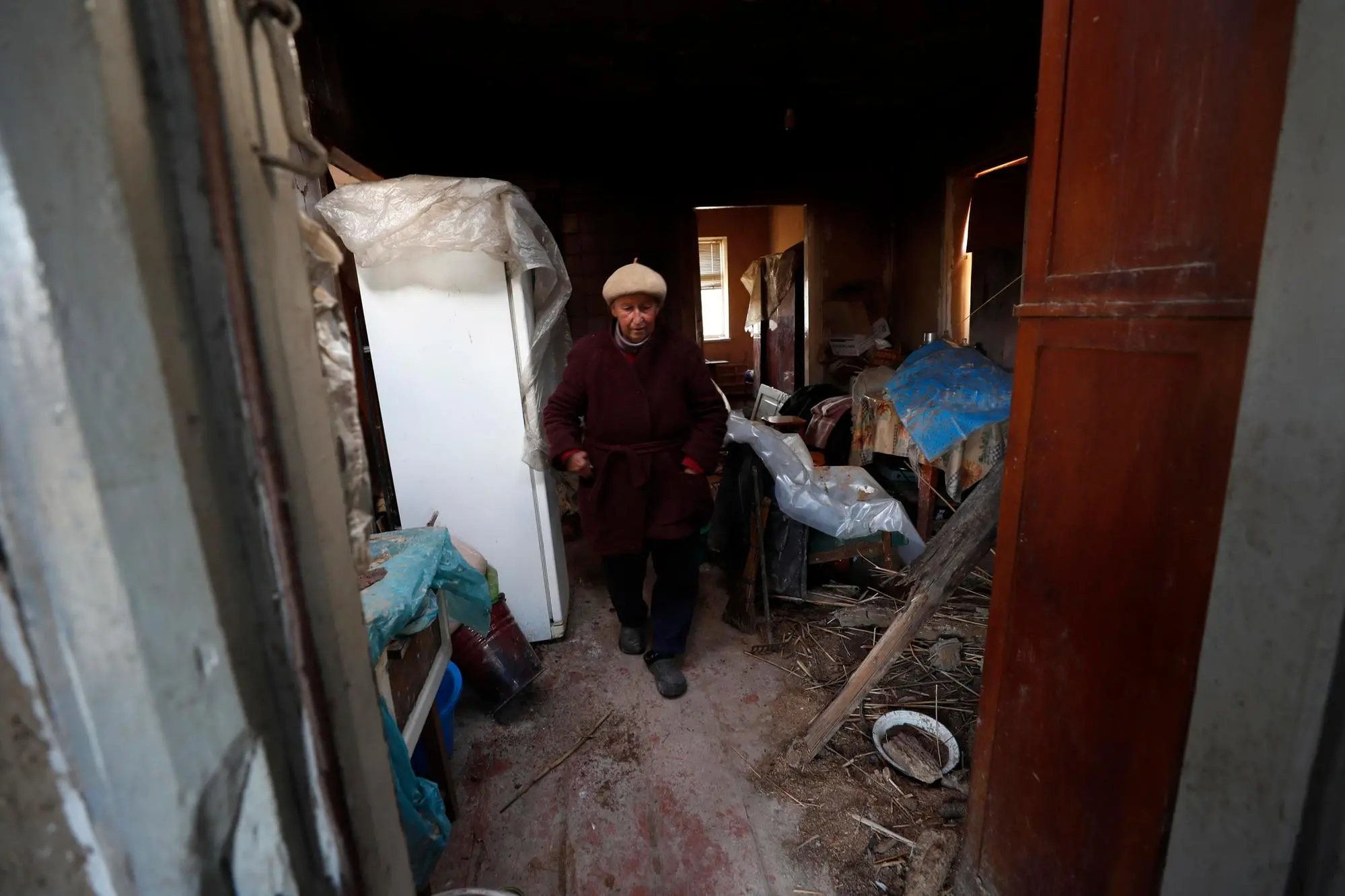 epa10241464 Ukrainian Lyudmila, 77, shows her destroyed house that she is still leaving in, in the city of Izyum, Kharkiv region, Ukraine, 13 October 2022. Kharkiv and surrounding areas have been the target of heavy shelling since February 2022, when Russian troops entered Ukraine territory starting a conflict that has provoked destruction and a humanitarian crisis. EPA/ATEF SAFADI
