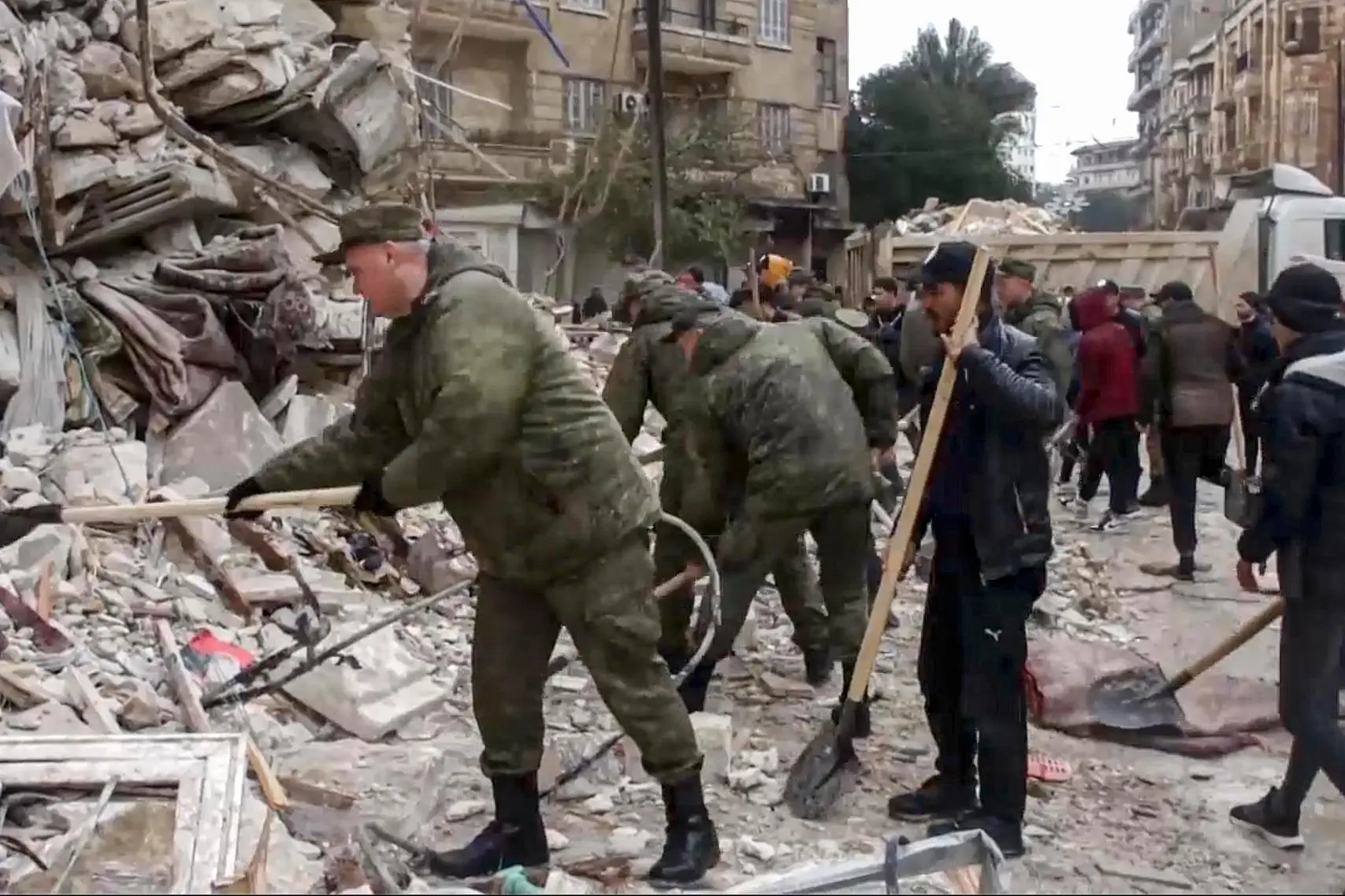 epa10452110 A still image taken from a handout video provided by the Russian Defence Ministry Press-Service on 07 February 2023 shows Russian servicemen helping locals search for victims at the site of a collapsed building after a major earthquake in Latakia, Syria. More than 4,000 people were killed and thousands more injured after a major 7.8 magnitude earthquake struck southern Turkey and northern Syria on 06 February. Authorities fear the death toll will keep climbing as rescuers look for survivors across the region. EPA/RUSSIAN DEFENCE MINISTRY PRESS SERVICE HANDOUT -- BEST QUALITY AVAILABLE -- MANDATORY CREDIT -- HANDOUT EDITORIAL USE ONLY/NO SALES