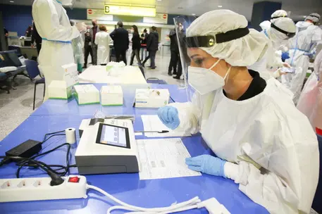 epa09061181 Medical personnel perform rapid Sars Cov-2 tests at Elmas Airport in Cagliari, Italy, 08 March 2021. EPA/FABIO MURRU