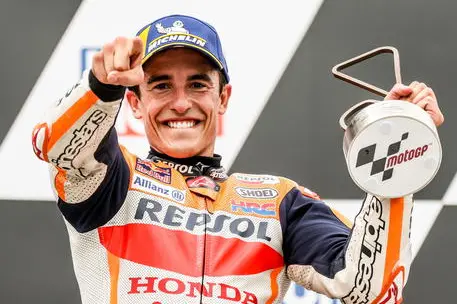 epa09288163 Spanish MotoGP rider Marc Marquez of the Repsol Honda Team celebrates on the podium after winning the Motorcycling Grand Prix of Germany at the Sachsenring racing circuit in Hohenstein-Ernstthal, Germany, 20 June 2021. EPA/FILIP SINGER